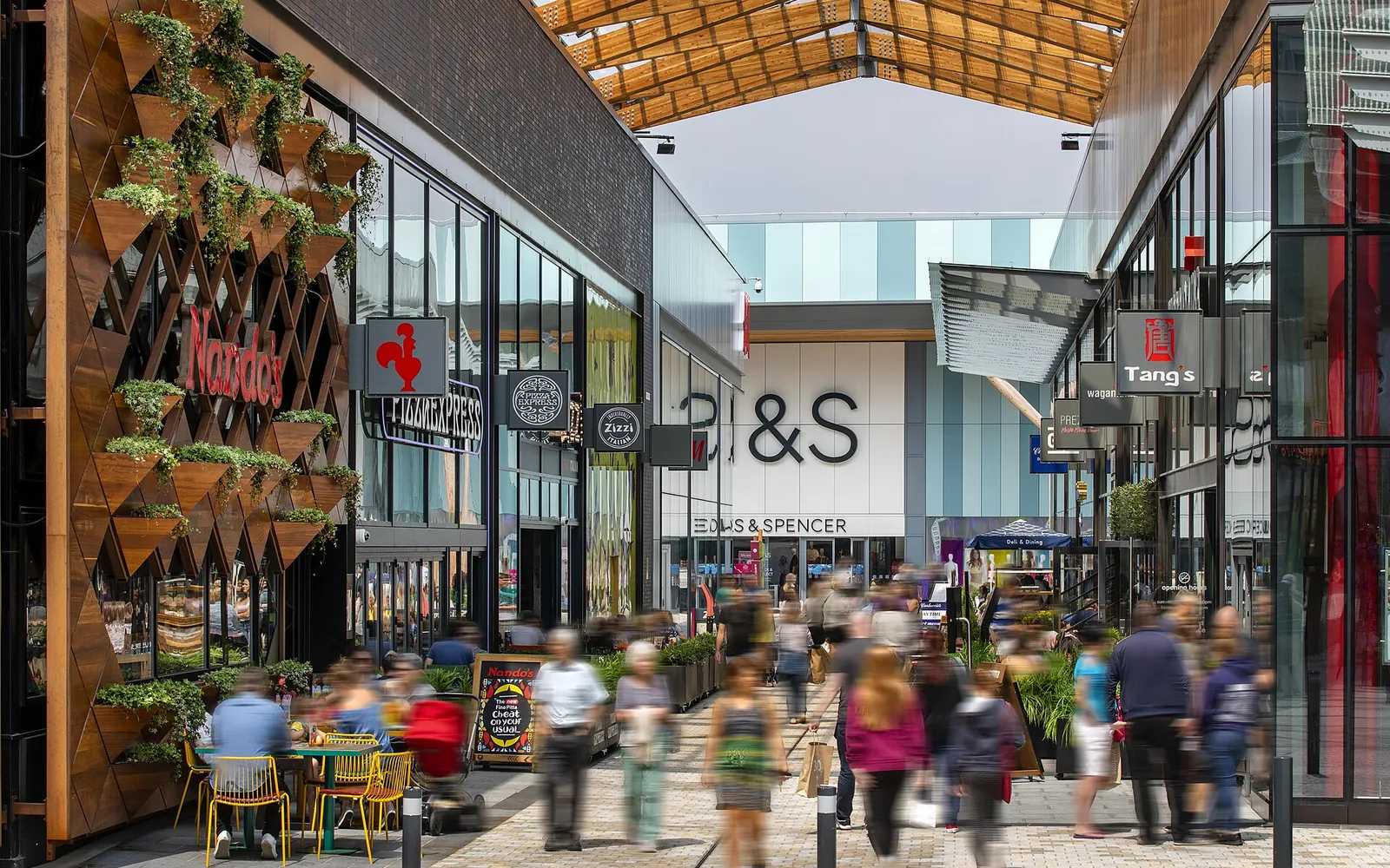 Shoppers and cafe tables in The Lexicon, Bracknell
