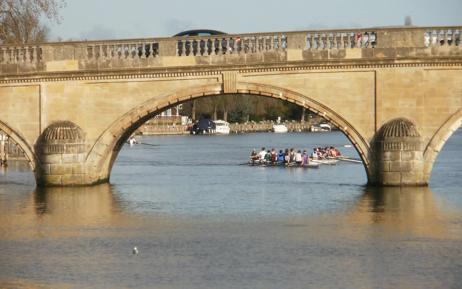 Rowers passing under an arch of Henley Bridge